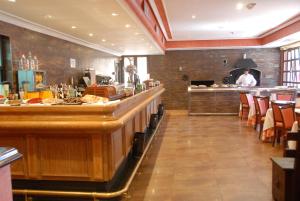 a kitchen with a lot of counter space at Hotel Juaneca in San Agustín de Guadalix