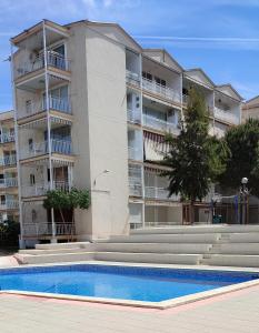 an apartment building with a pool in front of it at Marina's Calm in Salou