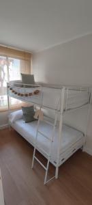 two bunk beds in a room with a window at Marina's Calm in Salou