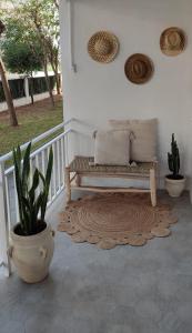 a porch with a bench and a potted plant at Marina's Calm in Salou