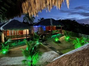 a resort with lights on the beach at night at Pousada Lanea Experience in Atins