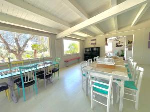 a dining room with tables and chairs and a large window at Borgo alto - Ideal holiday for families & friends in Noto