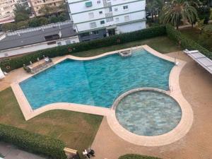 an overhead view of a large swimming pool at New Apartment Alejandro in Torre del Mar