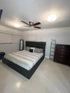 a bedroom with a bed and a ceiling fan at Modern Miami Oversized 3 Bedroom in Central Location in Miami