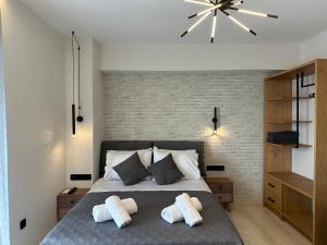 a bedroom with a bed with two pillows on it at Aphrodite Holiday Home in Rethymno