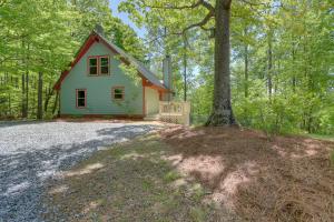 a small house in the woods with a tree at Blue Ridge Getaway with Hot Tub and Seasonal View! in Blue Ridge