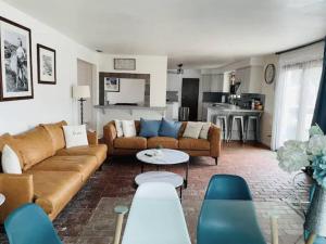 a living room with a couch and a table at Malibu Seaside Bliss with Hot Tub and Beach & Hike nearby in Malibu