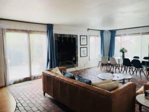 a living room with a couch and a table at Malibu Seaside Bliss with Hot Tub and Beach & Hike nearby in Malibu