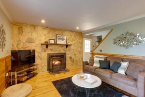 a living room with a couch and a fireplace at Blue Ridge Getaway with Hot Tub and Seasonal View! in Blue Ridge