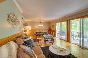 a living room with a couch and a table at Blue Ridge Getaway with Hot Tub and Seasonal View! in Blue Ridge