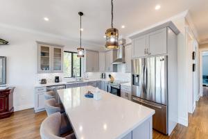a kitchen with white cabinets and a white counter top at Pure Aquamarine in Key Largo