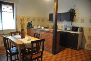 a kitchen with a table and a kitchen with a counter at Adri's House in Monterotondo