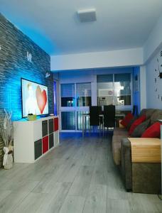 een woonkamer met een bank en een tv bij Apartamento Primera Línea de Playa in Torremolinos