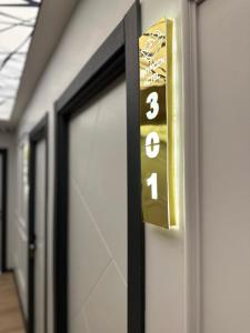 a door sign with the number three on it at Skymoon Istanbul Airport Hotel in Arnavutköy