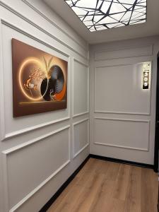 a room with a painting on the wall and a door at Skymoon Istanbul Airport Hotel in Arnavutköy