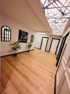 a large room with wooden floors and a skylight at Skymoon Istanbul Airport Hotel in Arnavutköy