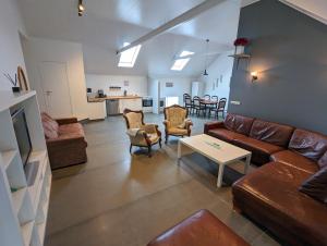 a living room with a couch and a table at Central Apartments in Vestmannaeyjar