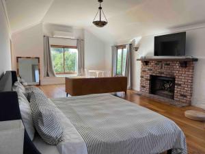 a living room with a bed and a fireplace at Malibu Coastal Romantic Getaway, Beach & Hike Nearby in Malibu
