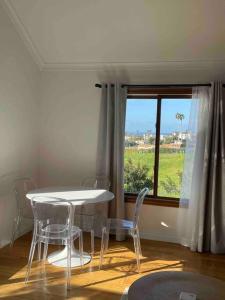 a table and chairs in a room with a window at Malibu Coastal Romantic Getaway, Beach & Hike Nearby in Malibu