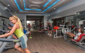 a woman exercising on a treadmill in a gym at Mirage Apartments & Aqua Park in Hurghada