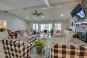 a living room with a couch and a tv at Hot Springs Village Lakehouse Near Golfing! in Hot Springs Village