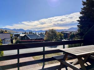 a wooden bench sitting on top of a balcony at Clearview - Lake Tekapo in Lake Tekapo