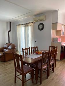 a dining table and chairs in a living room at Ajla’s home in Vorë