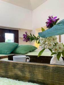 a bedroom with two beds and a vase with flowers at Il camino felice - 201 by Houset in Monza +16 photos