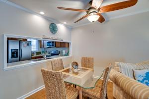 a dining room with a table and chairs and a couch at Coastal Vacation Rental - 2 Mi to Huntington Beach in Myrtle Beach