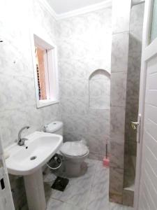 a bathroom with a sink and a toilet at 5 bedrooms house at Markaz Al Alamein 700 m away from the beach with shared pool enclosed garden and wifi in El Alamein