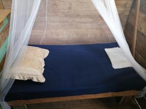 uma cama num quarto com uma rede mosquiteira em Bribri ù sule em Suretka