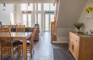 a dining room and living room with a table and chairs at One Mill Lands in Uig