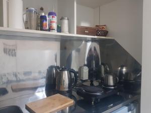 a kitchen counter with a stove with pots and pans at Mimi House in Posadas