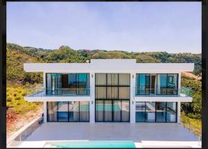 a rendering of a house with glass windows at Villa Ocean Blue in Las Terrenas