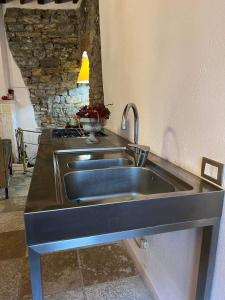 a kitchen with a stainless steel sink in a counter at La Piazzetta Toscana B&B in Campiglia Marittima