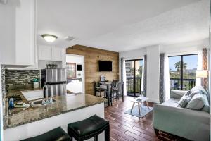 a kitchen and living room with a counter top at The Enclave - Unit 1601 in Orlando