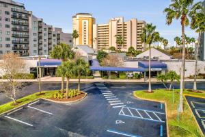 an empty parking lot with palm trees and buildings at The Enclave - Unit 1601 in Orlando