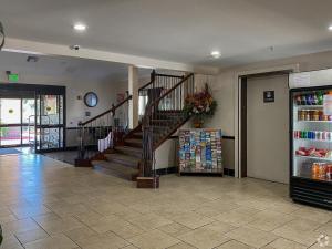 a lobby with a spiral staircase in a store at GreenTree Inn - IAH Airpot JFK Blvd in Houston