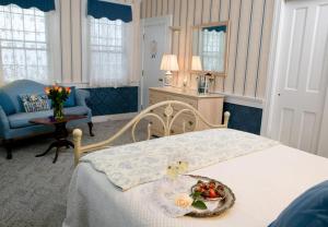 a bedroom with a bed with a plate of fruit on it at Rabbit Hill Inn in Lower Waterford