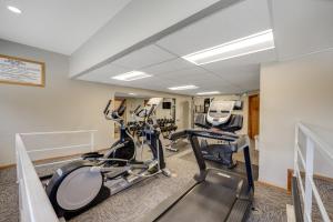 a gym with two treadmills and two exercise bikes at Pine Ridge Condos in Breckenridge