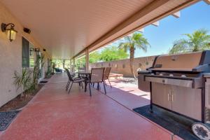 a patio with a grill and a table and chairs at Bella Vista La Quinta Home with Pool and Spa! in La Quinta