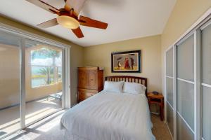 a bedroom with a bed and a ceiling fan at Lagoon Sunrise 205 in Carlsbad