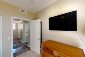 a living room with a flat screen tv on the wall at Lagoon Sunrise 205 in Carlsbad