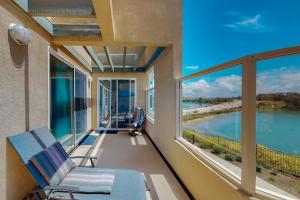 a balcony with a chair and a view of the water at Lagoon Sunrise 205 in Carlsbad