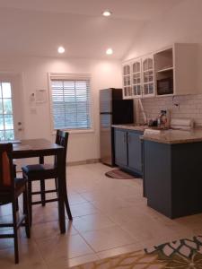 a kitchen with a table and a table and chairs at Windsor place in Hermitage