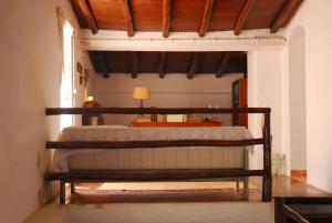 a bedroom with a bed and a table with a lamp at Azoia Wind Mill in Azoia