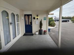 a front door of a house with a blue door at Colonial on Tay in Invercargill