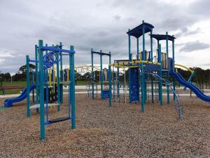 a playground with a blue and yellow slide at Spacious 3-bedroom home close to town and beach in Saint Leonards