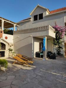 a pile of wood sitting outside of a house at Apartments with parking space Povlja, Brac - 21089 in Povlja