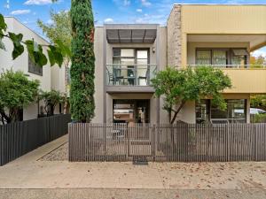 an apartment building with a fence in front of it at Central Shepparton Apartments in Shepparton